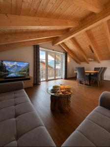 a living room with a couch and a table at Alpenwohnung Neuner in Wallgau