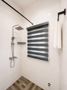 a white bathroom with a window and a shower at Little Afrika in Port Harcourt +132 photos