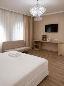 a hotel room with a bed and a chandelier at Sultan Beibarys in Astana