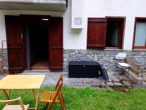 a table and chairs in front of a house at monolocale Sabrina in Torgnon +1 photo