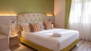 a large white bed in a room with a window at Hotel Castello Artemide Congressi in Castel San Pietro Terme +91 photos