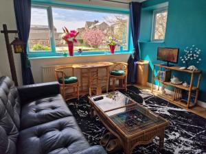 a living room with a couch and a table at Host & Stay - Beachcomber Cottage Apartment in Morecambe