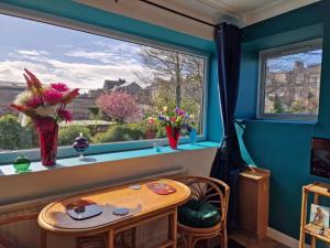 a room with a table and a large window at Host & Stay - Beachcomber Cottage Apartment in Morecambe +18 photos