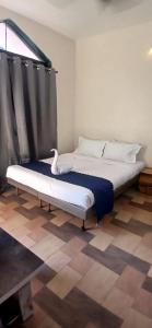 a large bed in a room with at Coastal Gateway Resort in Revadanda