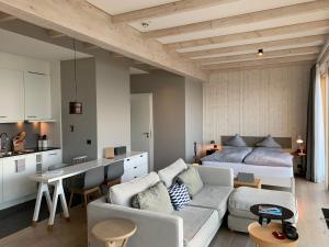 a living room with a couch and a bed at Inselloft Norderney in Norderney
