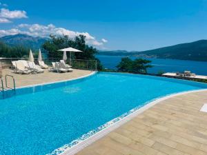 a swimming pool with a view of the water at Acacia Hills D8 in Herceg Novi in Herceg-Novi