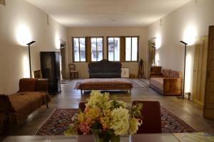 a living room with a couch and a table at DIMORA STORICA ZACCHI D'ARRIGO in Belluno