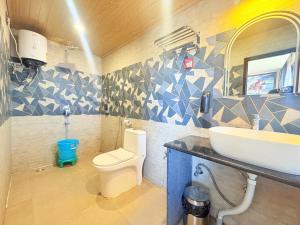 a bathroom with a toilet and a sink at The Potola Hotel And Restaurant With Parking Facility in Darjeeling +26 photos