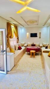 a living room with a couch and a table at Farm near Marrakech , Location ferme Marrakech in Marrakesh