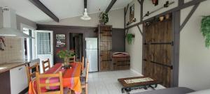 a kitchen with a table and a wooden door at Le résinier in Mimizan
