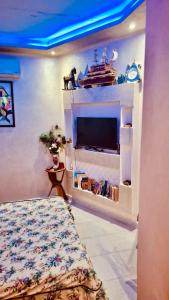 a bedroom with a bed and a tv in a room at Farm near Marrakech , Location ferme Marrakech in Marrakesh