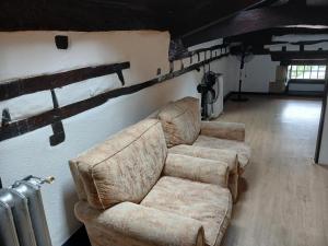 a living room with two couches and a radiator at Hosteria De Quijas in Quijas