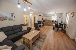 a living room with a couch and a table at Przystań Hartowiec in Ostaszewo