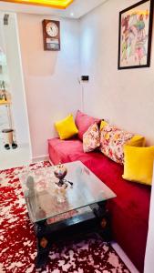 a living room with a red couch and yellow pillows at Farm near Marrakech , Location ferme Marrakech in Marrakesh