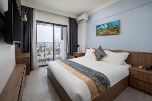 a bedroom with a large bed and a balcony at M9 Kirirom Hotel in Phnom Penh +74 photos
