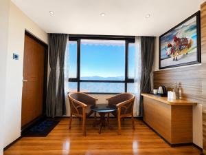 a room with a table and two chairs and a window at The Potola Hotel And Restaurant With Parking Facility in Darjeeling