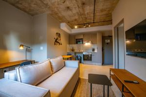 a living room with a couch and a kitchen at BlackBrick Bedfordview ApartHotel in Johannesburg