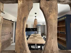 a kitchen and dining room with a table and trees at Quilleret in Haut-Mauco