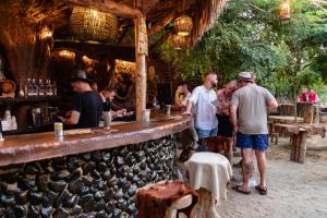 a group of people standing around a bar at Astoha in Durrës