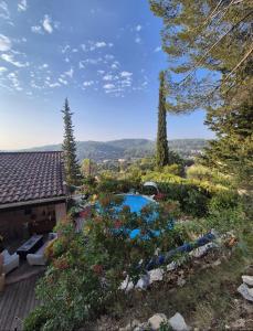 a house with a swimming pool in a garden at La Parenthèse Provençale in Cabasse