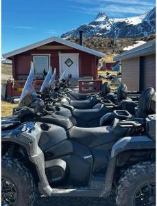 a row of atvs parked in front of a building at Isi4u apartments, snowmobile and dogsled in Sisimiut +2 photos