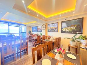 a dining room with tables and chairs in a restaurant at The Potola Hotel And Restaurant With Parking Facility in Darjeeling