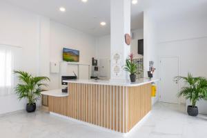 a lobby with a counter with potted plants at Ona el Marqués in Puerto de Santiago +43 photos