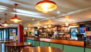 a bar with wooden tables in a restaurant at Sunset View - with view of the lighthouse and a shower and bath in Lossiemouth