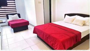 a bedroom with a bed with a red blanket at Hotel Lii View in Mersing