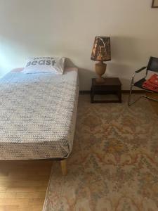 a bedroom with a bed and a table with a lamp at Alexis 1 in Novara +7 photos