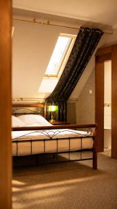 a bedroom with a large bed with a window at Stara Szkoła Boutique Hotel in Wronki +35 photos