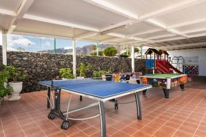 a room with two ping pong tables and a playground at Ona el Marqués in Puerto de Santiago