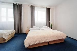 a bedroom with two beds and a large window at Sami Swoi Kutno in Kutno