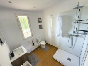 a white bathroom with a shower and a toilet at Cyclolodge in Altea +35 photos