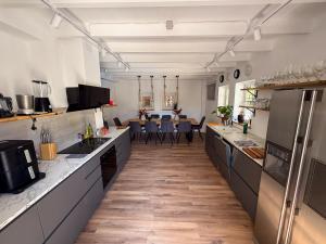 a large kitchen with a counter and a dining room at Cyclolodge in Altea