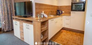 a small kitchen with a sink and a counter at Haus Sonneneck in Schwangau