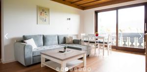 a living room with a couch and a table at Haus Sonneneck in Schwangau