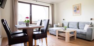 a living room with a table and a couch at Haus Sonneneck in Schwangau
