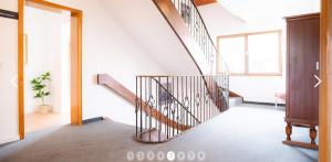 a hallway with a spiral staircase in a house at Haus Sonneneck in Schwangau
