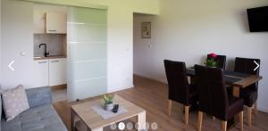 a living room with a dining room table and a kitchen at Haus Sonneneck in Schwangau +21 photos