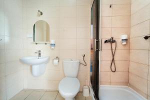 a bathroom with a toilet and a sink and a shower at Sami Swoi Kutno in Kutno
