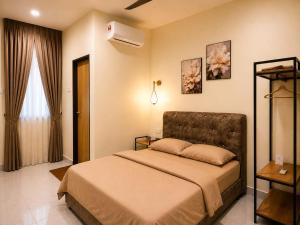 a bedroom with a bed and a air conditioner at iHomie Suites - 4Bedroom Homestay Kulim in Kulim