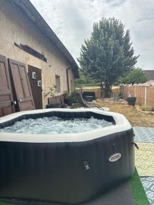 a large hot tub sitting in a yard at Hélios ranch in Varennes-le-Grand