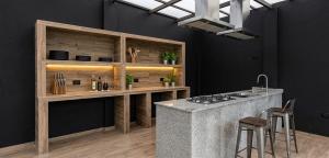 a kitchen with a stove and a counter with stools at Hangar pista36 in Hacienda Santa Rosa