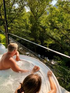 a boy and a girl in a hot tub at Villa Boutique 1880-Romantic Historic Boutique Hotel with Outdoor Jacuzzi in San Salvador