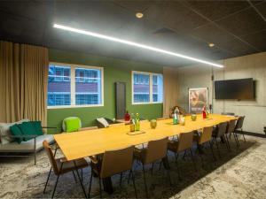 a conference room with a long table and chairs at ibis Styles Amiens Centre in Amiens