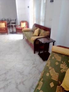 a living room with a couch and a table at دار المحبة - Dar El Mahabba in Tazarka