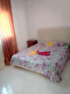 a bedroom with a bed with a comforter with ducks on it at دار المحبة - Dar El Mahabba in Tazarka
