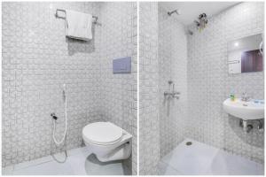 a bathroom with a shower and a toilet and a sink at FabHotel City Inn in Hyderabad