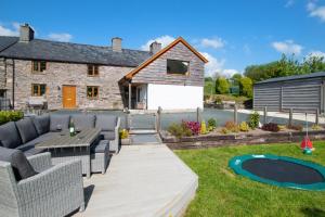 a garden with a patio and a house at 6 Bed in Machynlleth oc-bow374 in Cemmaes
